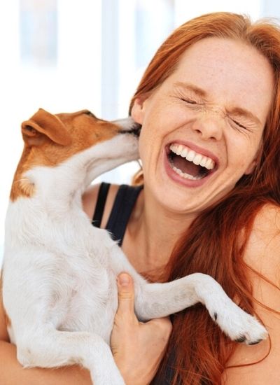 dog licking womans face